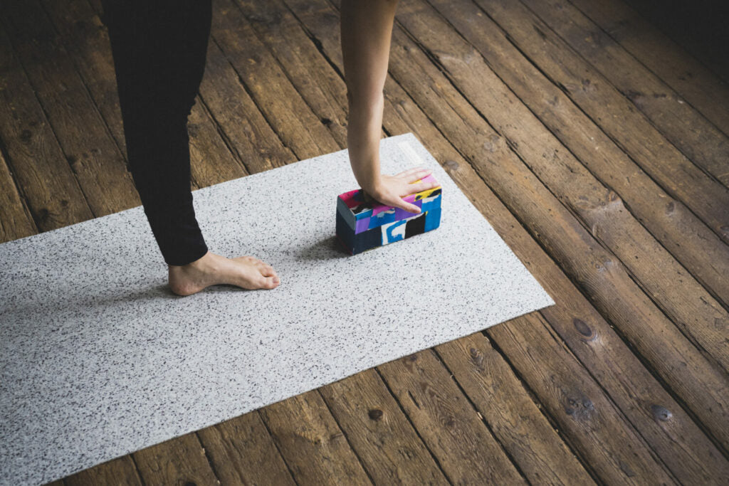 yoga block out of flip-flops is used as a yoga prop during the yoga practice